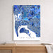 Map of San Diego in blue tones on a white wall above a wooden shelf.