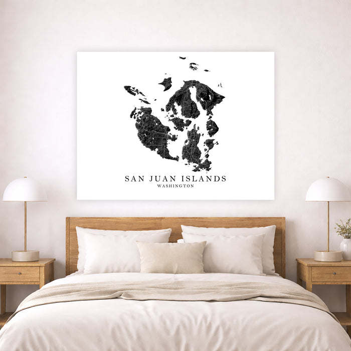Map of San Juan Islands hanging above a bed in a bedroom.