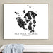 Framed map of San Juan Islands, Washington on a wall above a white bench.