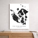 Map of San Juan Islands, Washington on a white wall above a wooden shelf.