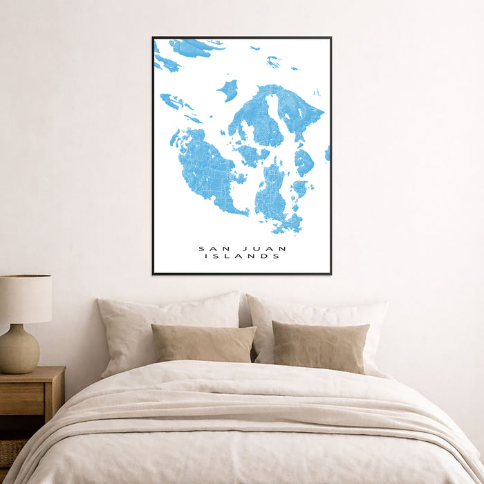 Framed map of San Juan Islands above a bed in a bedroom