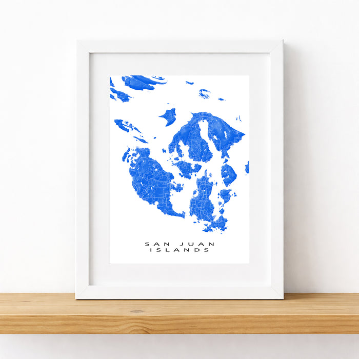 Framed map of San Juan Islands with blue ink blots on a white background