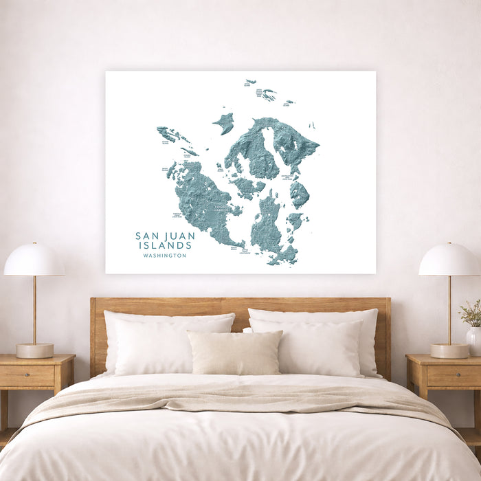 Map of San Juan Islands hanging above a bed in a bedroom.