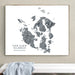 Framed map of San Juan Islands, Washington on a wall above a white surface.