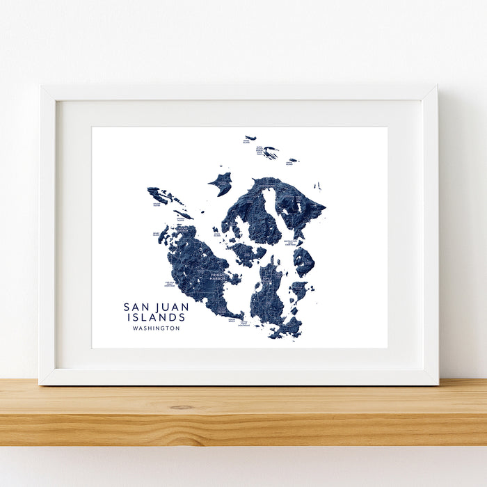 Framed map of San Juan Islands, Washington on a white wall.