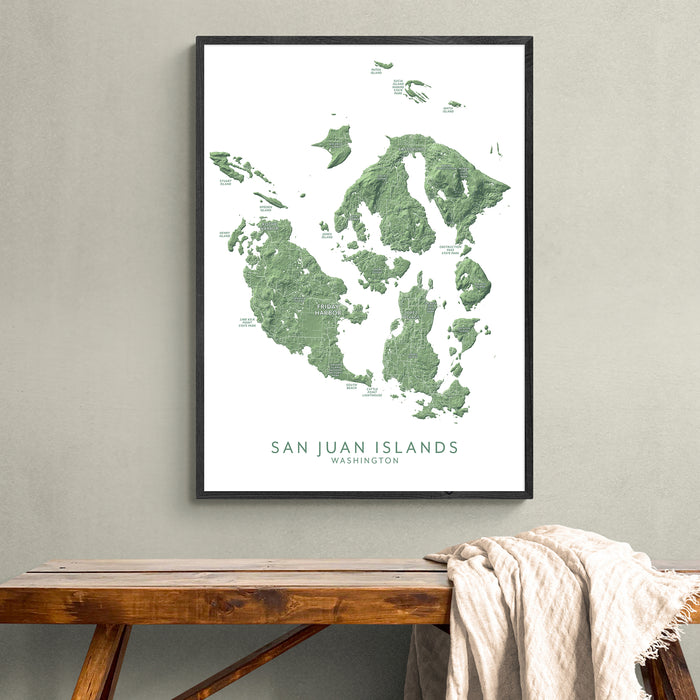Framed map of San Juan Islands on a wall above a wooden bench.