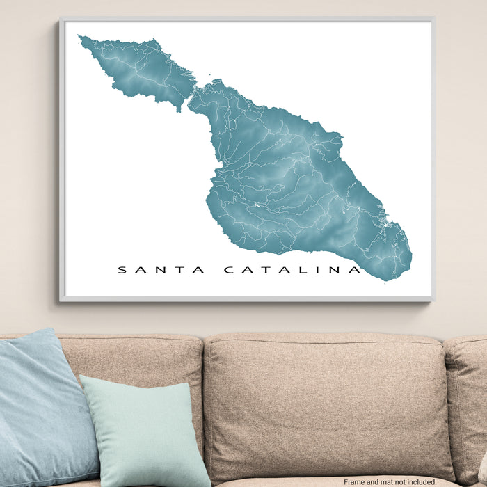 Framed map of Santa Catalina on a wall above a beige sofa with light blue pillows.