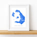 Framed map of Santorini on a white wall