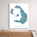 Map of Santorini on a white wall above a wooden shelf.