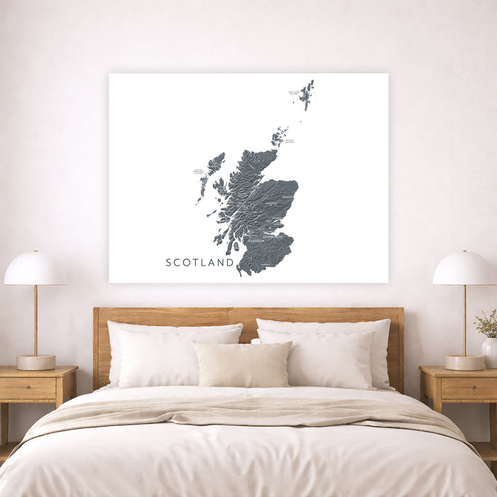 Map of Scotland on a wall above a bed in a bedroom setting