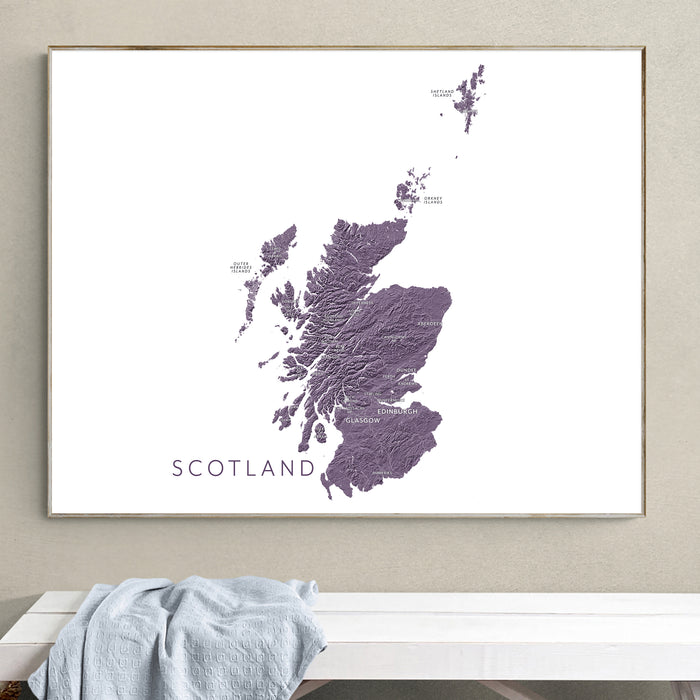 Framed map of Scotland on a wall above a white bench.