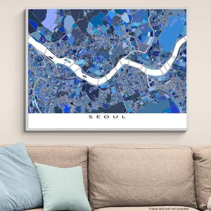 Map of Seoul on a wall above a beige sofa with light blue pillows.