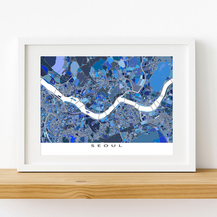 Framed map of Seoul with a blue color scheme on a white wall.