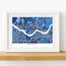 Framed map of Seoul with a blue color scheme on a white wall.