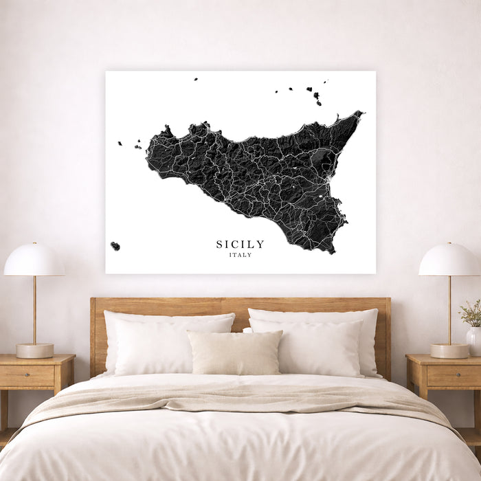 Map of Sicily on a wall above a bed in a bedroom setting