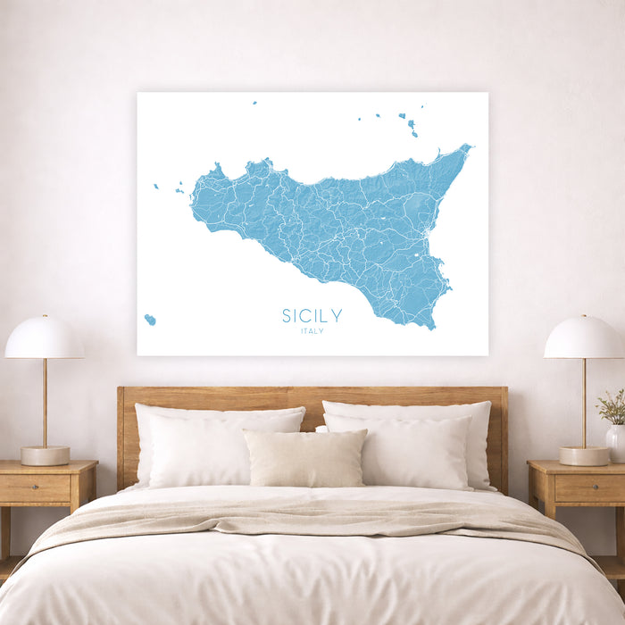 Map of Sicily on a wall above a bed in a bedroom