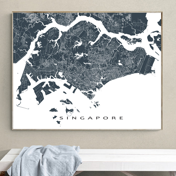 Framed map of Singapore on a wall above a white surface.
