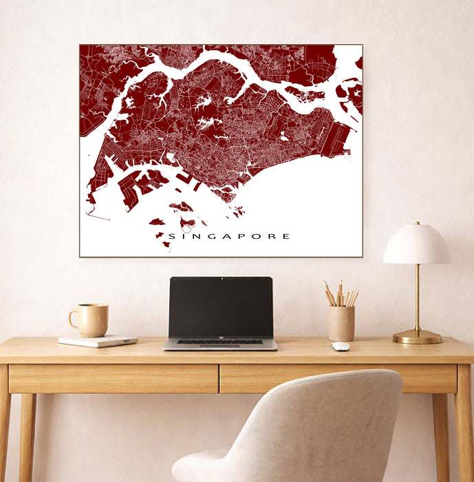 Map of Singapore on a wall above a desk with a laptop and lamp.