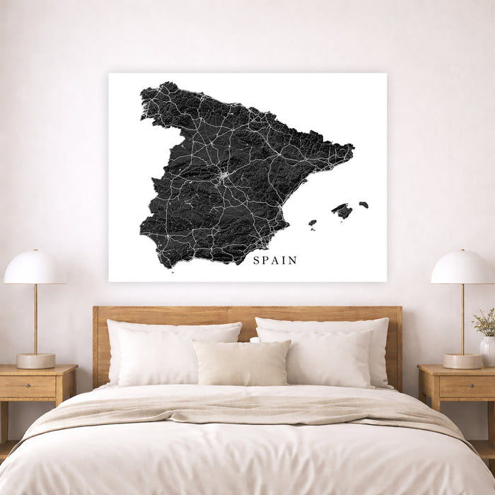 Map of Spain on a wall above a bed in a bedroom setting