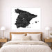 Map of Spain on a wall above a bed in a bedroom setting