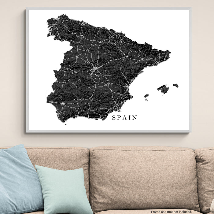 Framed map of Spain on a wall above a sofa