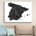 Framed map of Spain on a wall above a sofa