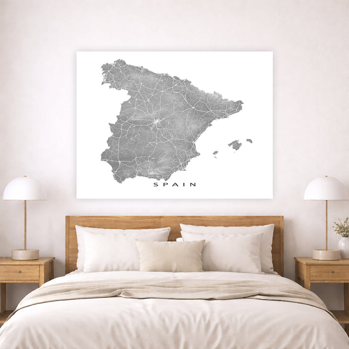 Map of Spain on a wall above a bed in a bedroom setting
