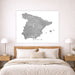 Map of Spain on a wall above a bed in a bedroom setting