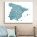 Map of Spain on a wall above a beige sofa with light blue cushions.