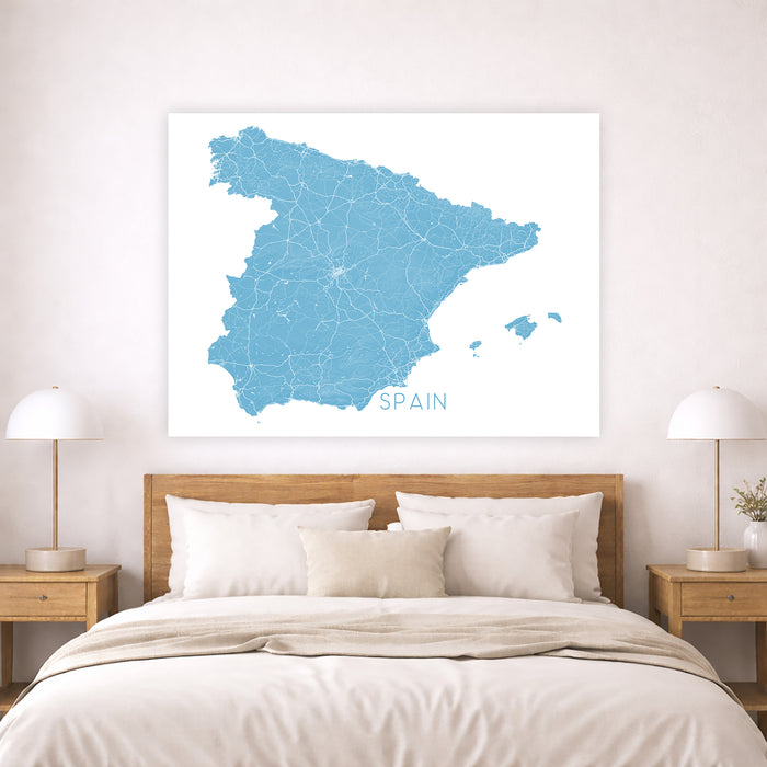 Map of Spain on a wall above a bed in a bedroom setting