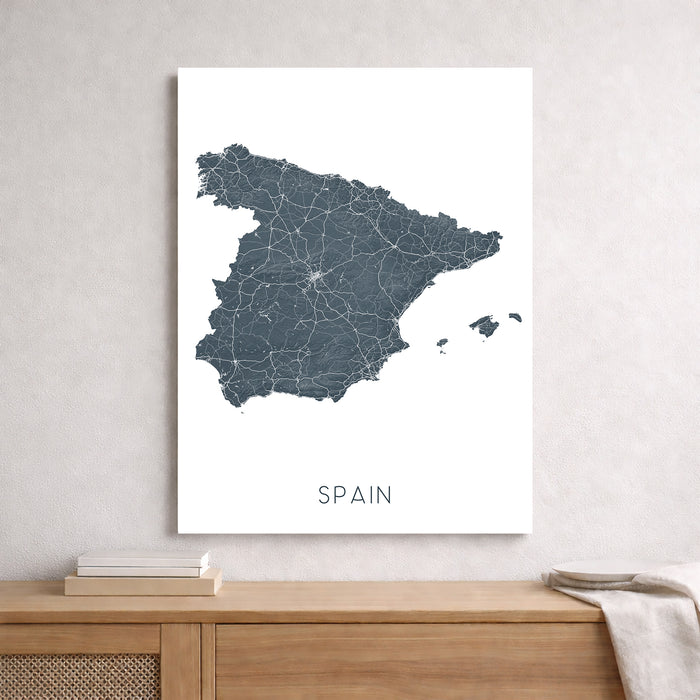 Map of Spain on a white background above a wooden surface.