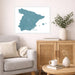 Living room with a map of Spain on the wall, a vase with plants, and a wooden cabinet.