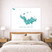 Map of Saint Barthelemy on a wall above a bed in a bedroom.