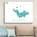 Framed map of Saint Barthélemy on a wall above a beige sofa with light blue pillows.