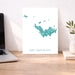 Map of Saint Barthélemy on a desk with a laptop and plant