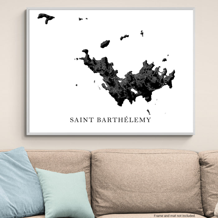 Framed map of Saint Barthélemy on a wall above a sofa.