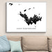 Framed map of Saint Barthélemy on a wall above a sofa.