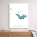 Map of Saint Barthélemy on a white wall above a wooden shelf.