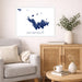 Living room with a gray sofa, wooden cabinet, and decorative items including a map of Saint Barthelemy.