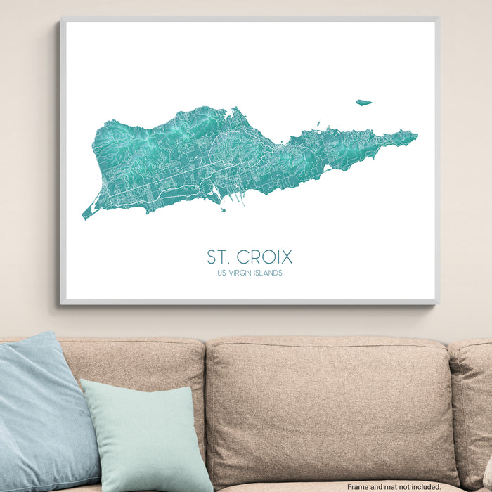 Framed map of St. Croix, US Virgin Islands on a wall above a beige sofa with light blue pillows.