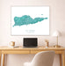 Teal map of St. Croix on a wall above a desk with a laptop and lamp.