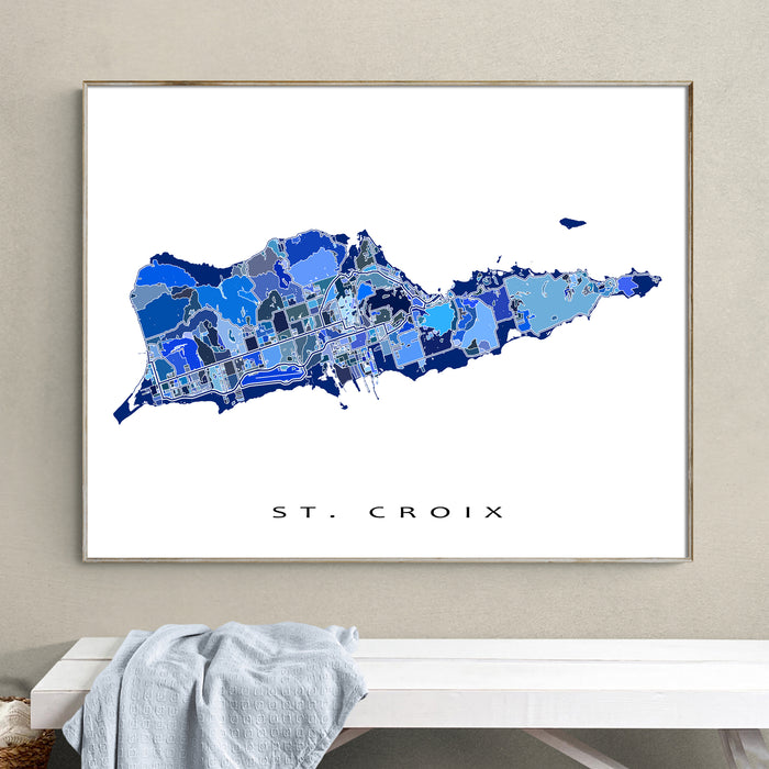 Framed map of St. Croix on a wall above a bench.