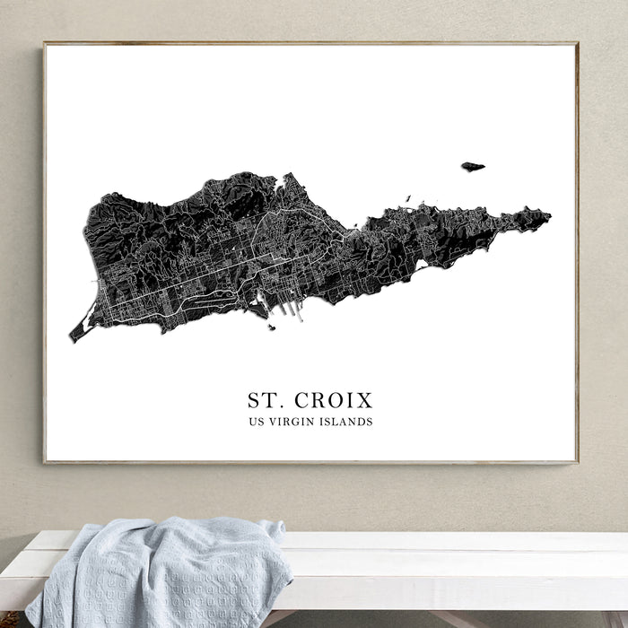 Framed map of St. Croix, US Virgin Islands on a wall above a white bench.