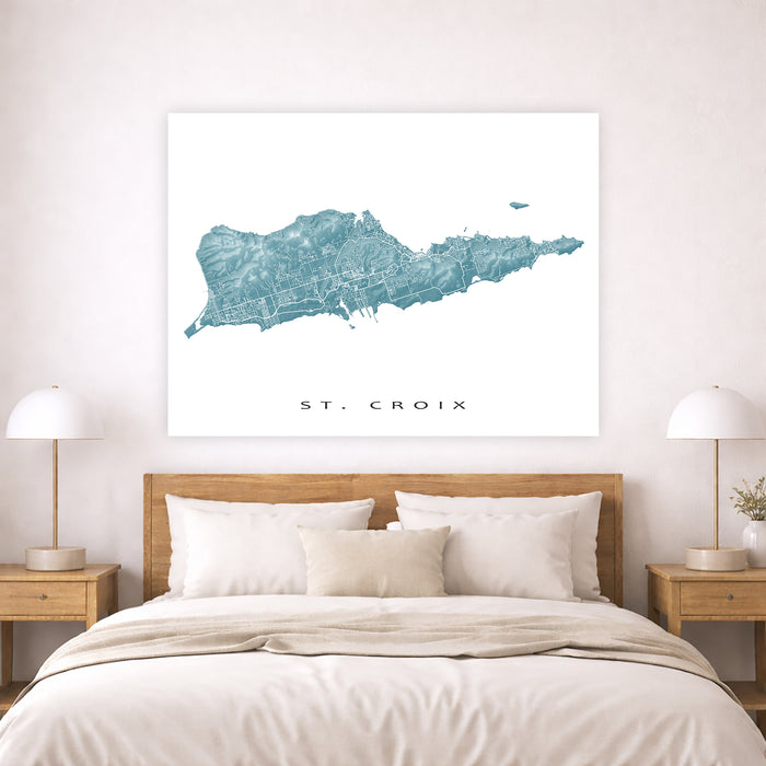 Map of St. Croix on a wall above a bed in a bedroom setting