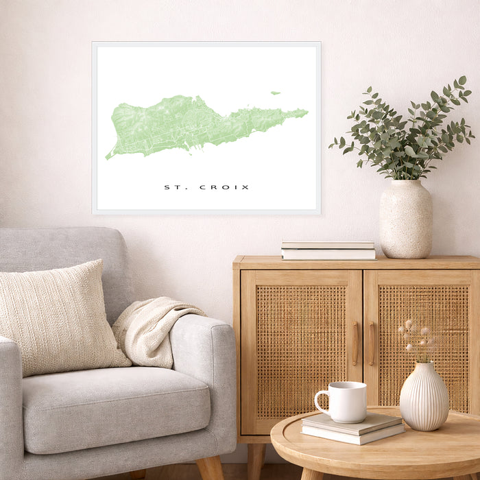 Living room with a map of St. Croix on the wall, a couch, and a wooden cabinet.