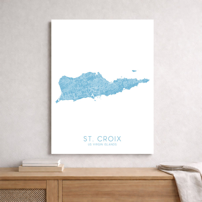 Map of St. Croix, US Virgin Islands, displayed on a wall above a wooden shelf.