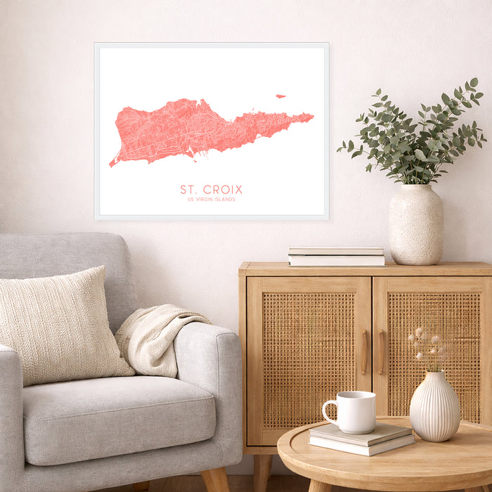 Living room with a gray sofa, wooden cabinet, and decorative items including a map of St. Croix.