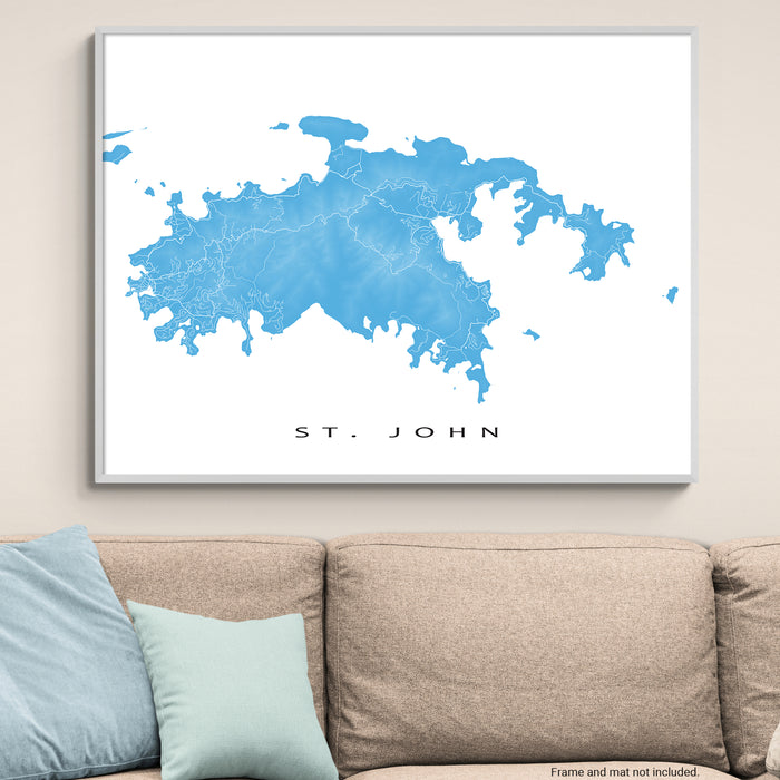 Framed map of St. John on a wall above a beige sofa with light blue pillows.