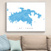 Framed map of St. John on a wall above a beige sofa with light blue pillows.