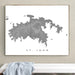 Framed map of St. John on a wall above a white bench.